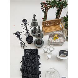 1:12 scale dolls house conservatory and garden accessories, including white wooden glazed conservatory on a stone effect base, black and white metal garden seating, barbecue, plant shelves, parasol, barbeque accessories, large planters, rabbit hutch, animals, chimenea, etc