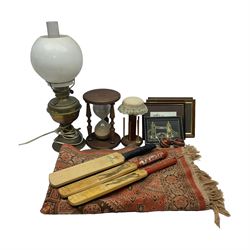 Two Art of Sport signature collection miniature cricket bats, another similar cricket bat, large wooden hourglass, converted brass oil lamp, bobbin holder, small rug and other collectables