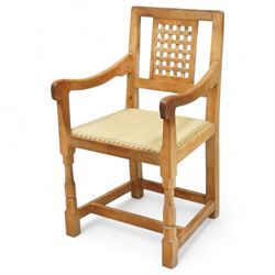 Mouseman - set of eight (7 + 1) oak dining chairs, pierced and carved lattice back over leather upholstered seat, on octagonal front supports united by stretchers, carved with mouse signature, by the workshop of Robert Thompson, Kilburn