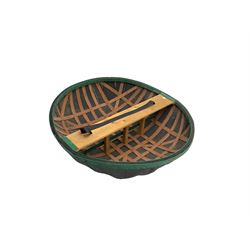 Coracle boat, comprised of woven planks and waterproof covering with single plank seat and strap