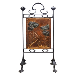  Arts and Crafts copper fire screen, central rectangular panel embossed with trees by a path with a sun in the distance, on a wrought iron frame decorated stylised foliage, attributed to John Pearson, H91cm x W48cm  