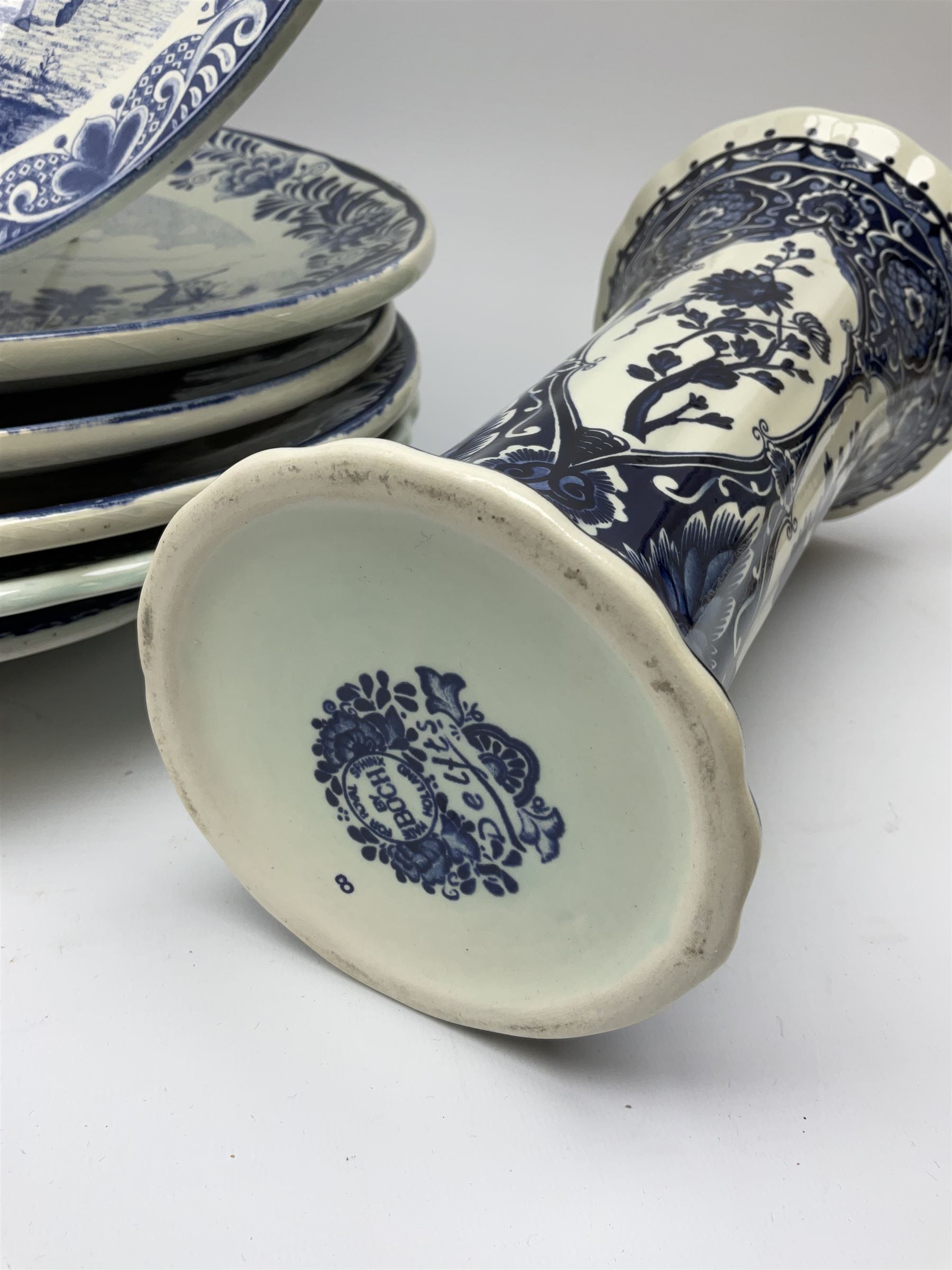 A large collection of modern transfer printed Delft ware, to include large baluster vase, H42cm, two jars and covers, largest H40cm, pair of tapering cylindrical vases, H31cm, and a number of plates of various size and design. 