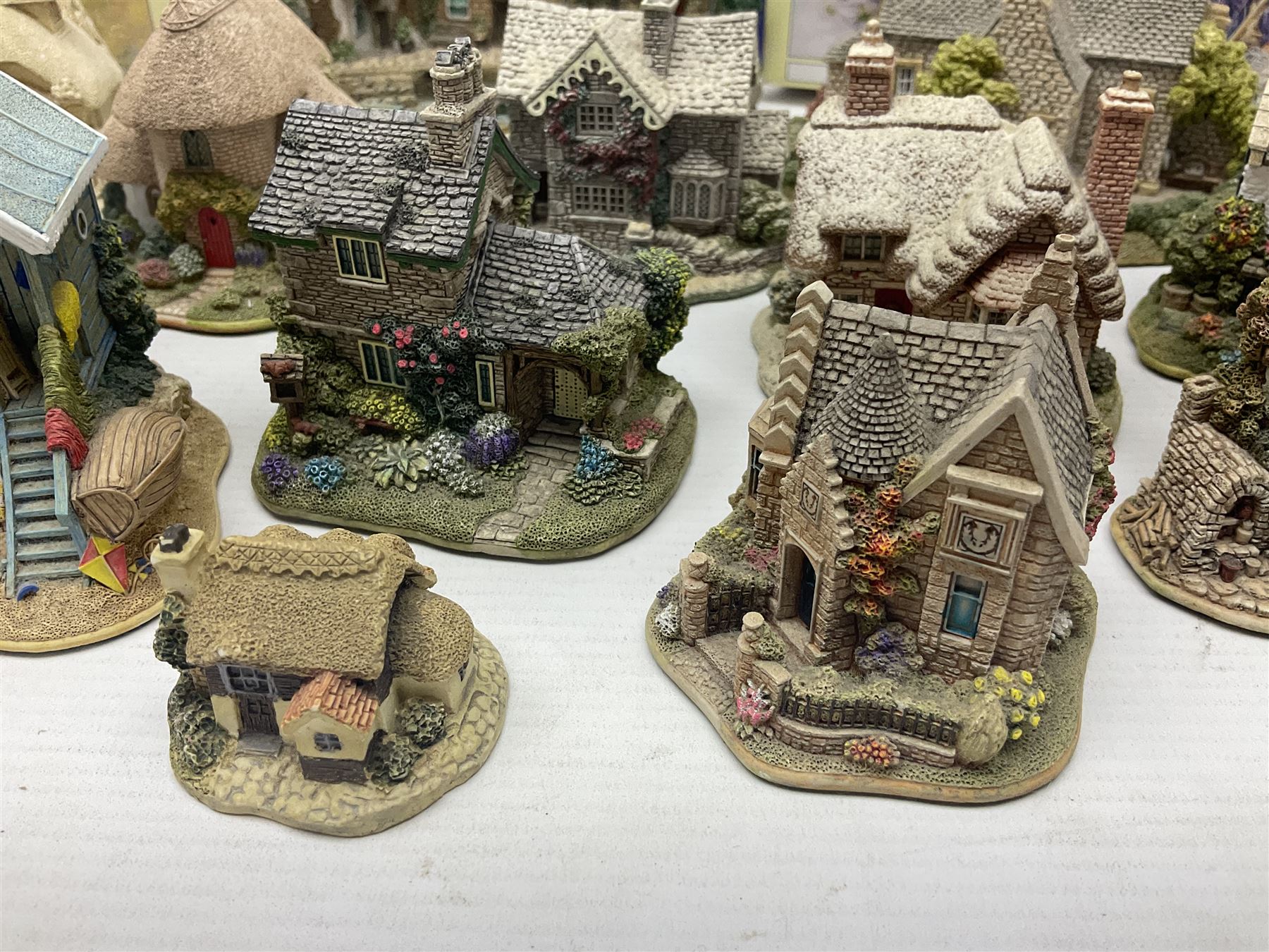 Twenty three Lilliput Lanes, including Village School, Lace's Shoe Shop, Cockles & Muscles, Scotland the Brave etc, together with The Leonardo Collection Paint Box Poppets and Gullivers World magazines 