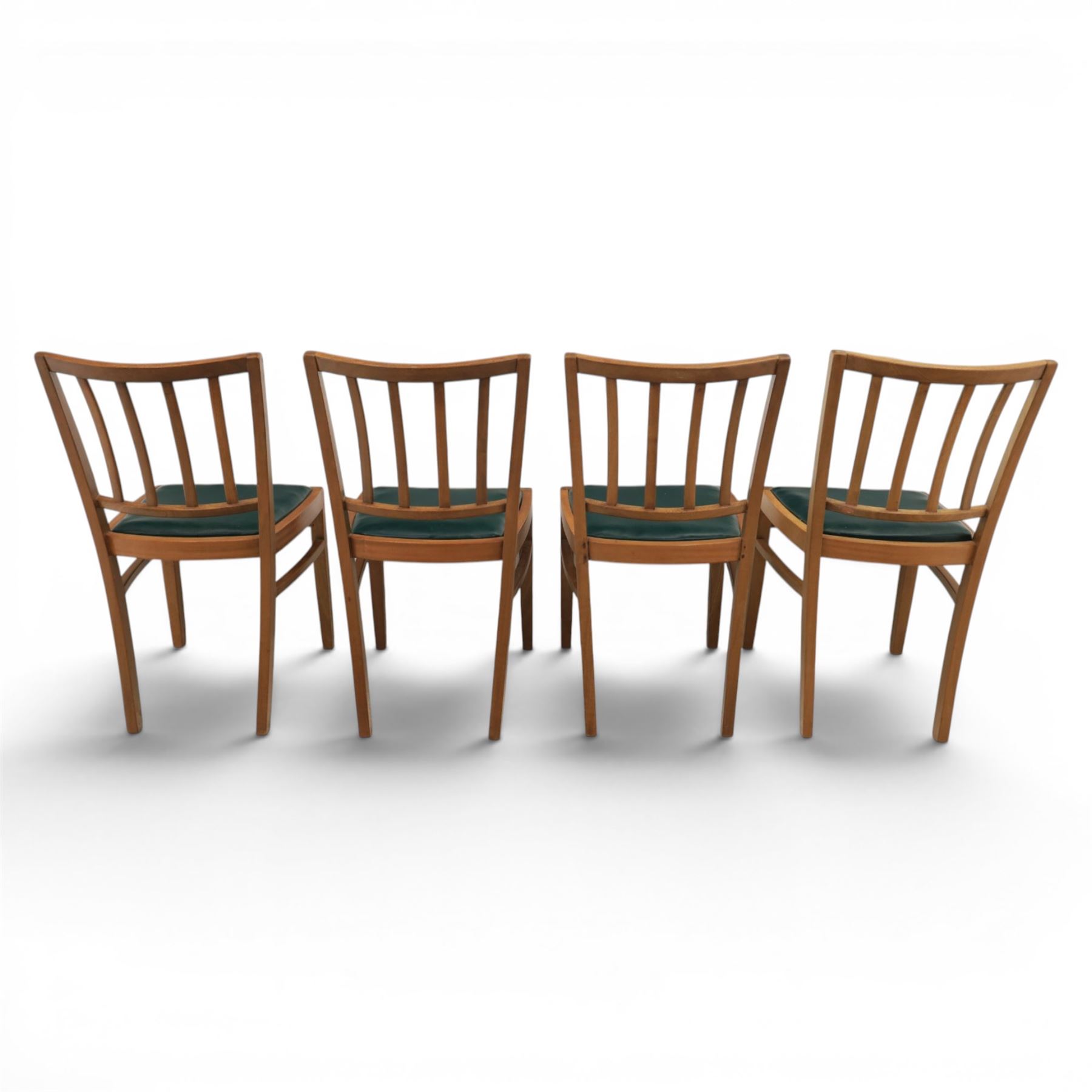 Mid 20th century teak extending dining table, together with eight teak chairs with green leather seats, extends to 154cm