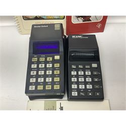 Four 1970s Sinclair electronic calculators - Cambridge in hard case with booklet; Scientific Programmable with Program Library and booklet; Scientific in hard case; and Oxford 300 in soft case with booklet; together with Texas PC-100 SR56 programmable slide-rule calculator on base station with readout, two booklets, keys and cover, serial no.9103093