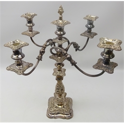  Old Sheffield plate five light candelabra, scroll arms, foliate embossed stem on shaped square base, H54cm   