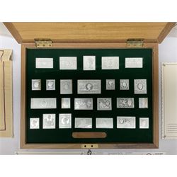 The Stamps of Royalty collection consisting of twenty-five sterling silver hallmarked stamp replicas, housed in a fitted wooden display case, with certificates, polishing cloth and certificates