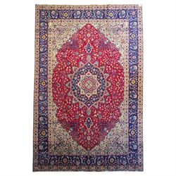 North West Persian Tabriz hand-knotted carpet, madder red field with a central cusped meda...