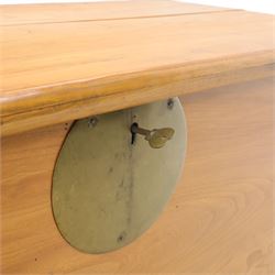 Burmese hardwood and brass inlaid marriage chest, the hinged top enclosing a fitted interior with small drawers, the front decorated with a circular brass medallion, raised on a plinth base