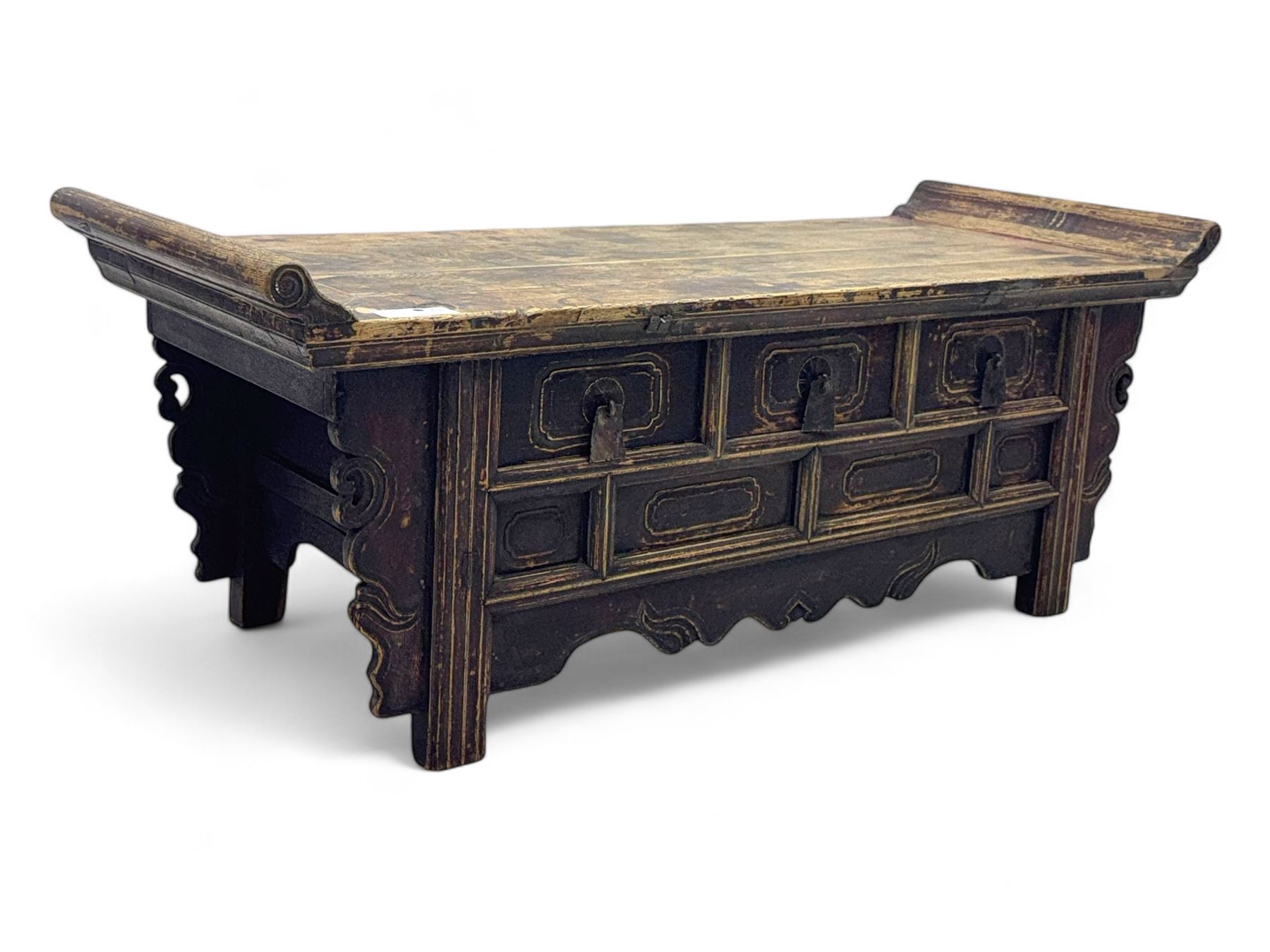 Mid-19th century elm low altar table, rectangular top with scrolled ends, fitted with three small drawers, pierced and scroll carved brackets, on square moulded supports 
