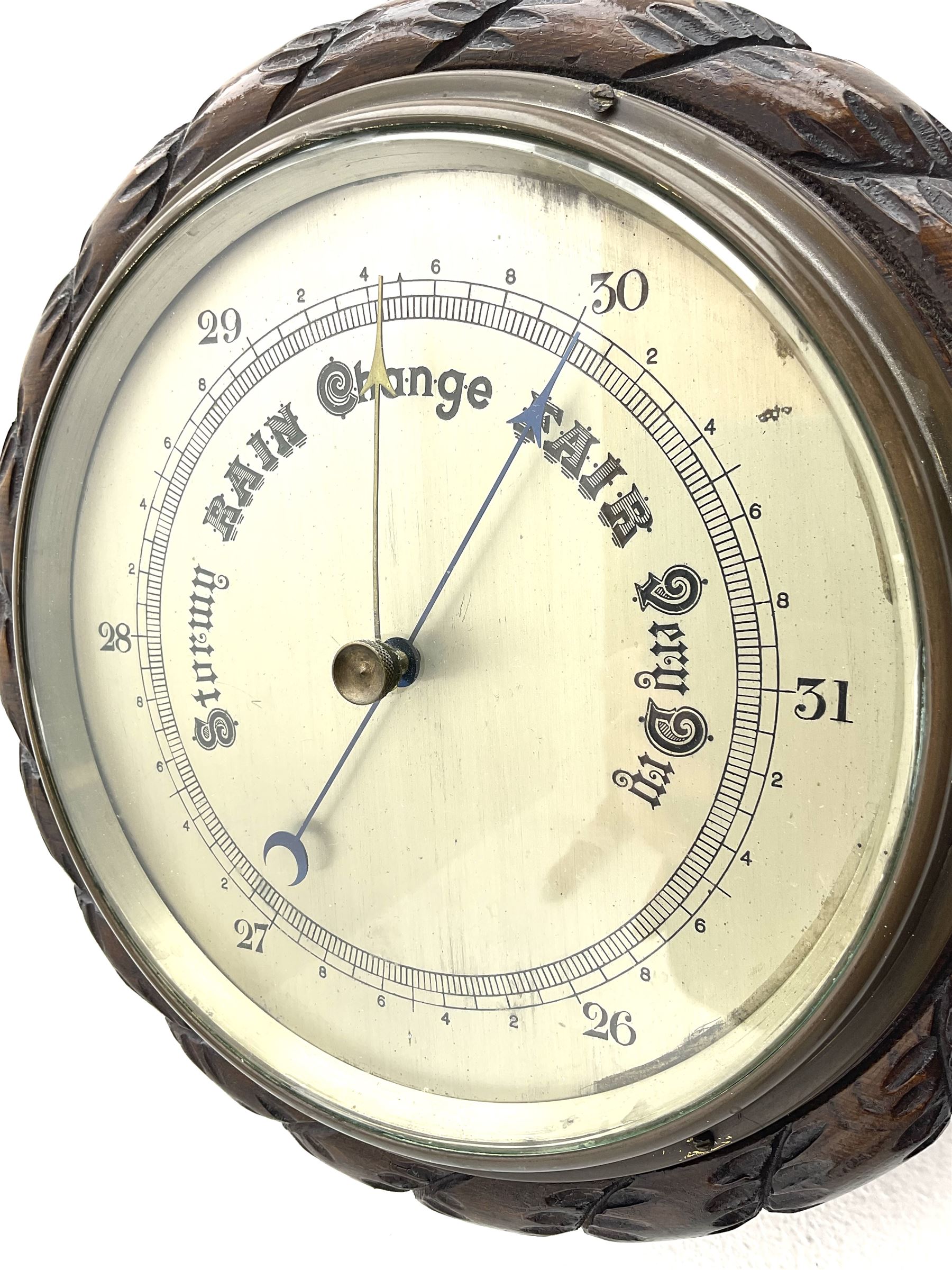 Mid 20th century circular oak cased barometer, silvered dial with register, rope carved edge moulding