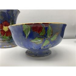 Royal Doulton Wild Rose pattern vase of flared form, painted with flowers on mottled blue ground, together with a matching footed bowl and shallow bowl, pattern no. D6227, c 1940, all with printed marks beneath, largest bowl D27cm (3)