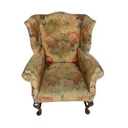 Early 20th century Georgian style wingback armchair, upholstered in floral fabric with sprung seat, walnut frame with front cabriole supports