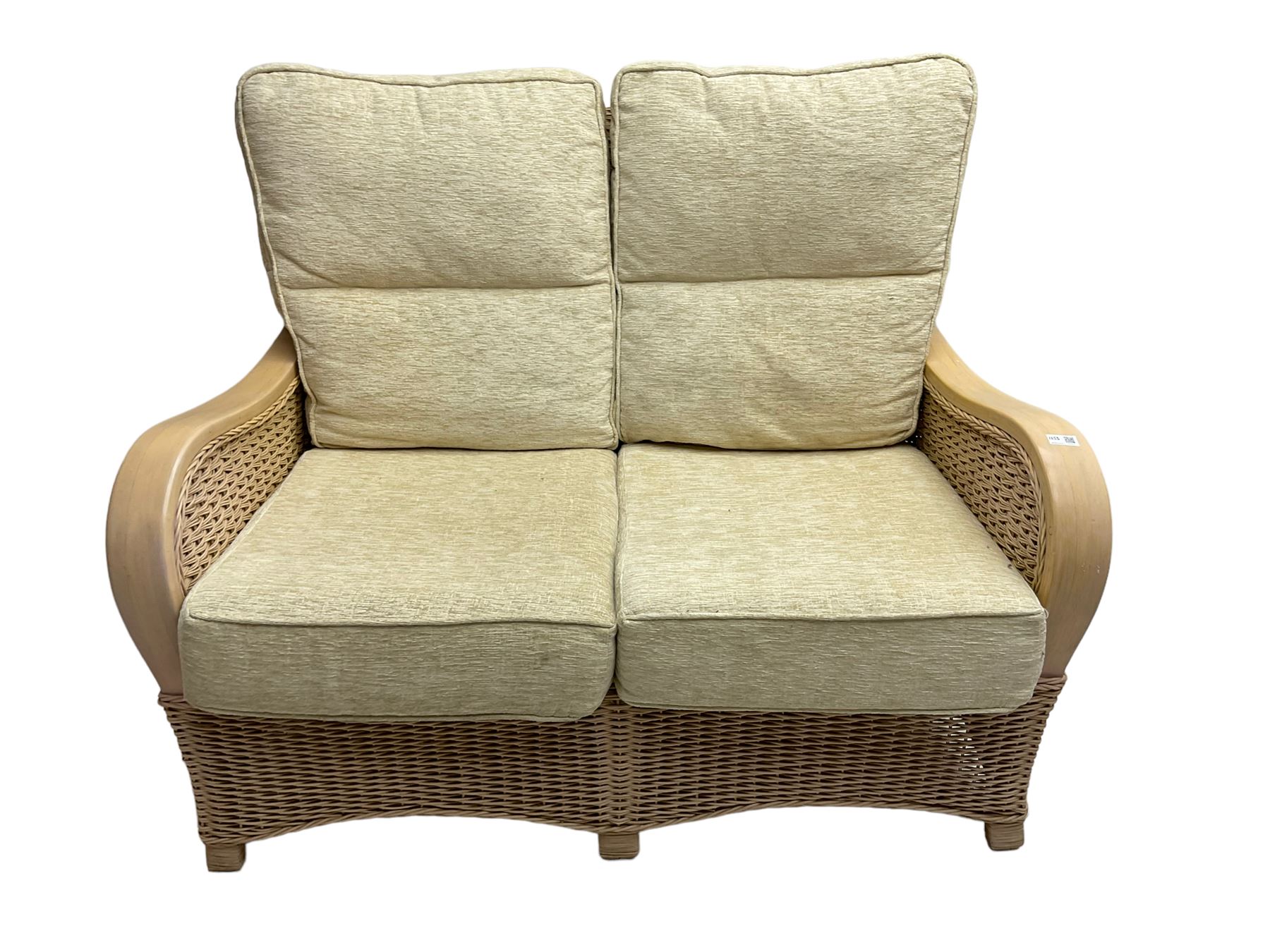 Contemporary rattan conservatory suite - two seat sofa with wicker frame and loose cushions upholstered in textured champagne fabric (W125cm H98cm); pair of matching armchairs (W72cm H98cm); rectangular glass-topped coffee table with rattan frame and undertier (W85cm D60cm H47cm); and matching square side table (W53cm H55cm)