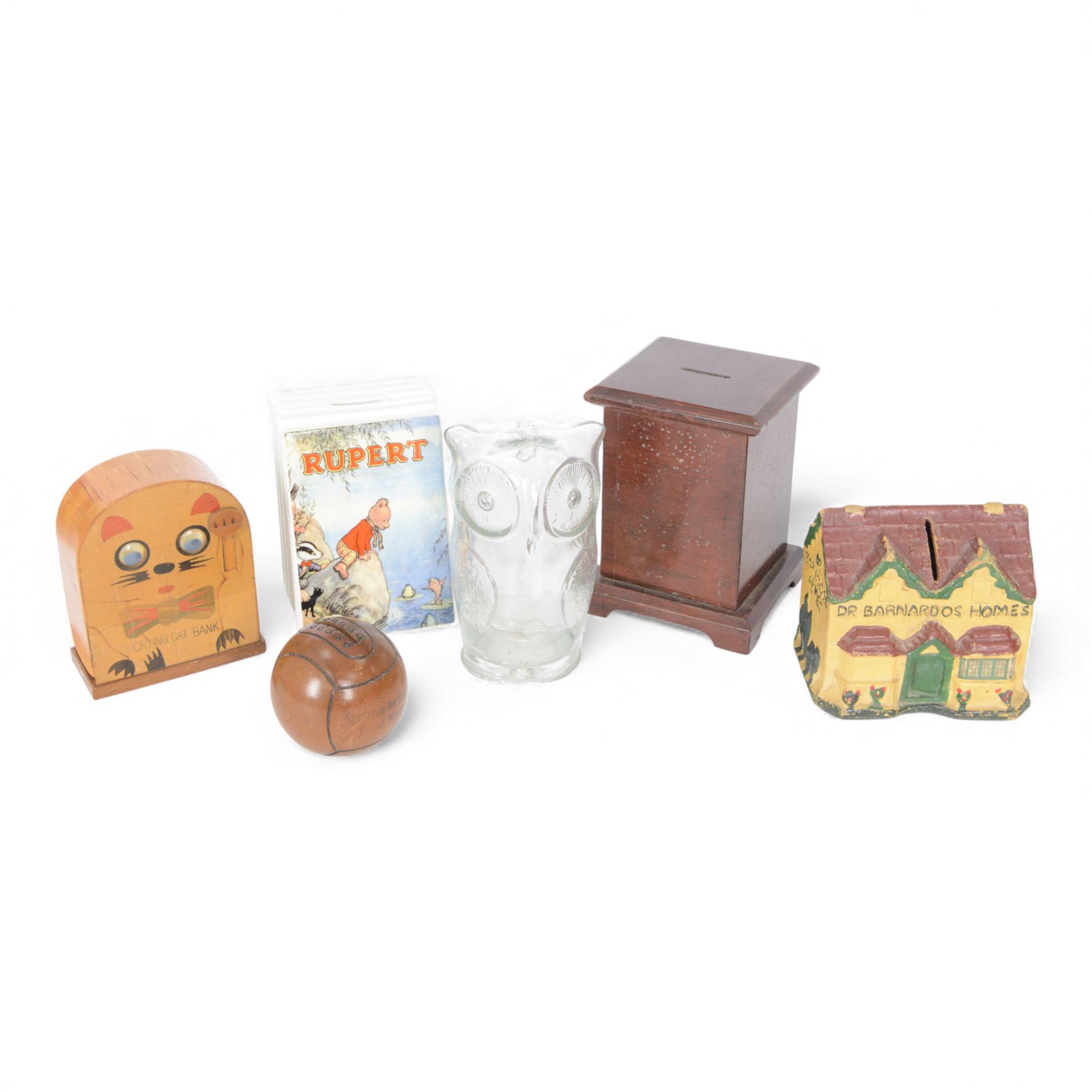 Six vintage money boxes, including papier mache Dr Barnados Homes, Wedgwood Rupert Bear, wooden crying cat, Berlin West baseball, glass owl, etc