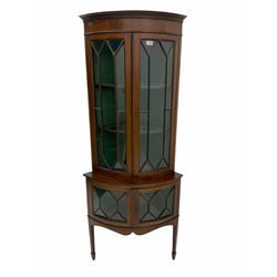 Early 20th century mahogany bow front corner cabinet on stand