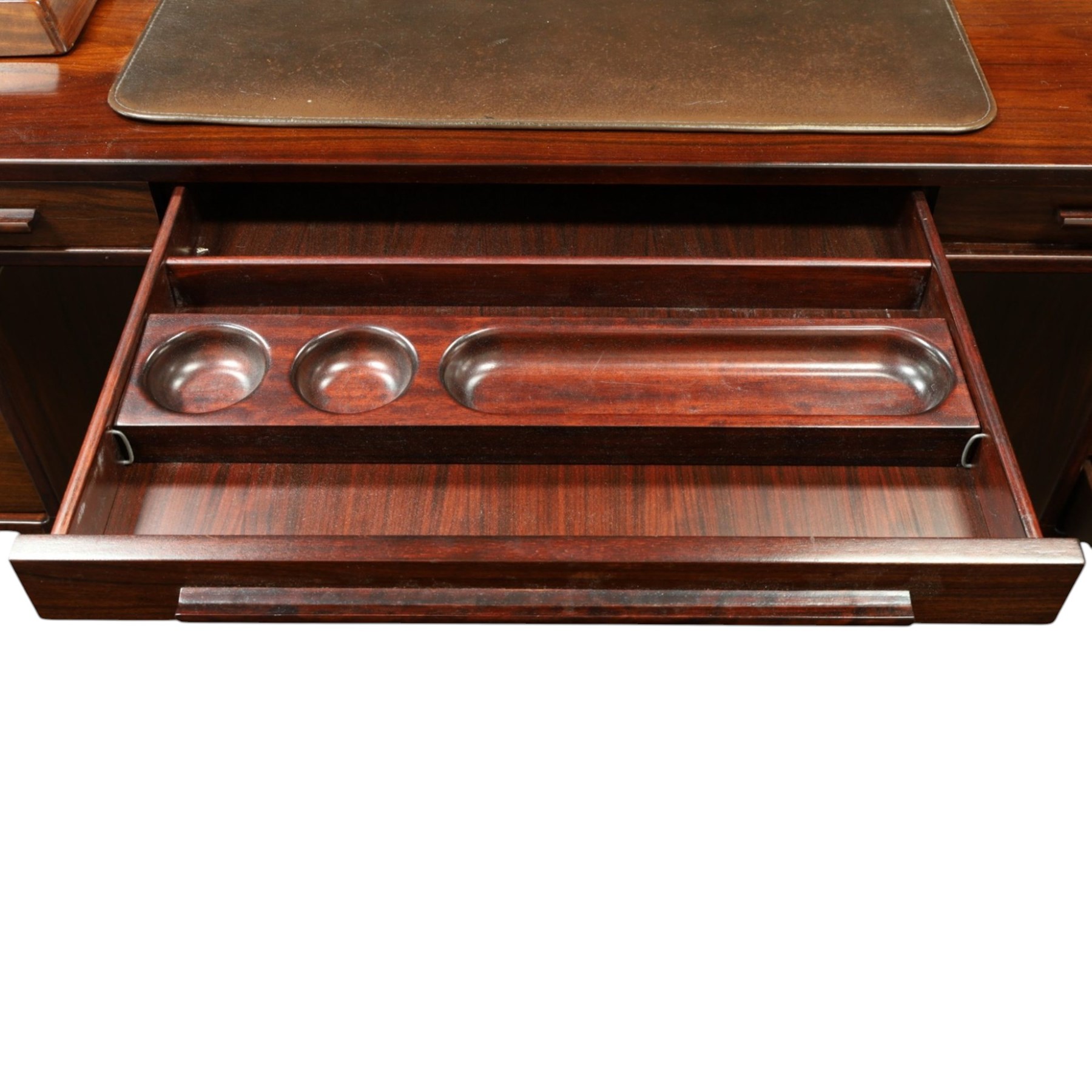 Dyrlund - Santos rosewood office suite, comprising an executive desk and cream leather upholstered swivel chair, the desk with a broad rectangular top with rounded corners, leather writing surface, pen compartments and letter tray, three lockable frieze drawers with fitted interiors above a central kneehole flanked by floating drawer pedestals, the left housing a filing drawer and the right three compartmented drawers, with a full width modesty panel to the reverse, chair raised on a castor base, H 116cm, W 62cm, D 74cm