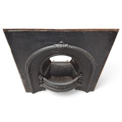 Late Victorian black-painted cast iron fireplace, the arched surround with anthemion cartouche and guilloche-moulded border, enclosing a bow-front fire basket with finialled standards, railed front and leaf-cast apron, with sheet-metal backplate