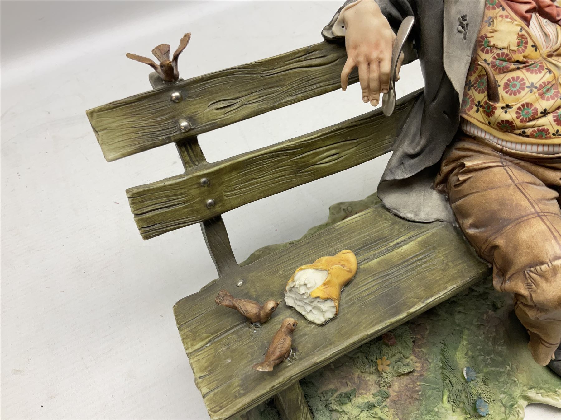 Two Capodimonte figures, comprising The Watchmaker by Curiase and Tramp Seated on a Bench, created by D.Bonalberti, tallest example H24cm