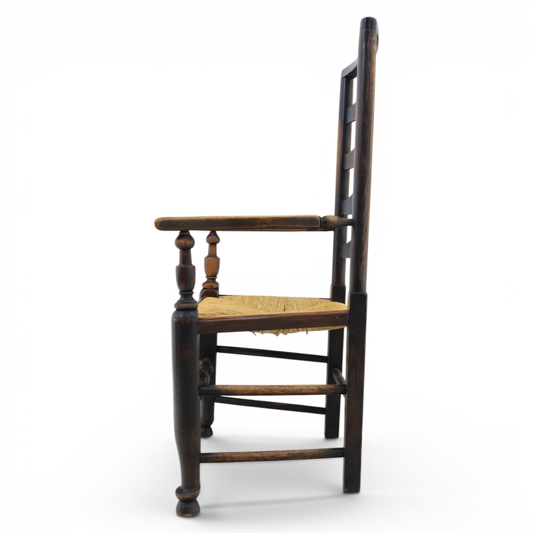 Set of seven (6+1) Georgian design country elm Lancashire dining chairs, ladder backs with rush seats, turned front leg stretcher on pad feet, height of seat 44cm, complete with fitted tie on cushions