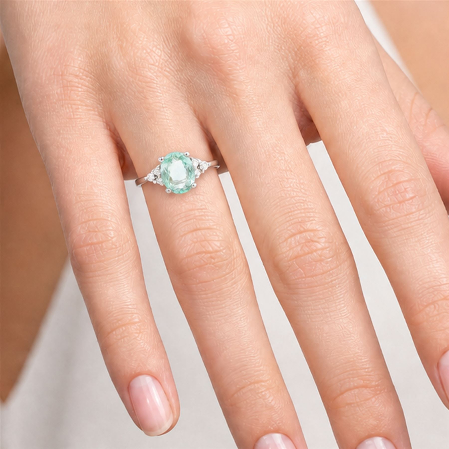 18ct white gold Paraiba tourmaline and diamond ring, single oval cut tourmaline of approx 0.95 carat, with three round brilliant cut diamonds set either side, Birmingham 2008