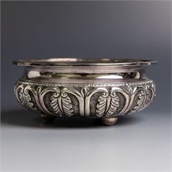 Indian silver bowl, of circular form with embossed acanthus leaf decoration, upon three bu...