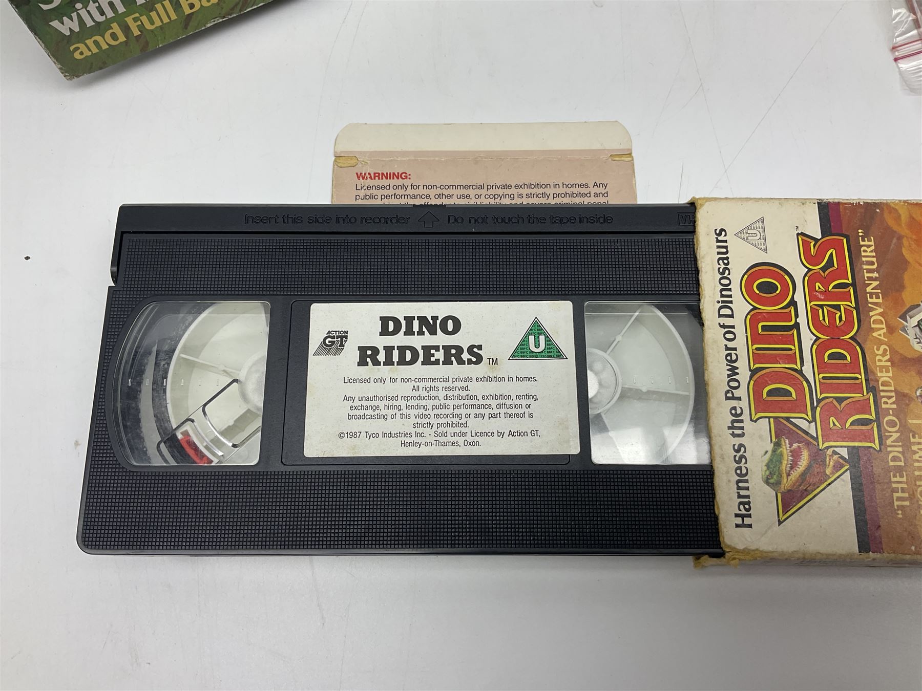 Dino-Riders 1980s by Tyco Action-GT, Stegosaurus with Tark and Vega Heroic Dino-Riders; Triceratops with Hammerhead and Sidewinder Evil Rulon Warriors; and Struthiomimus with Nimbus Heroic Dino-Rider; all boxed; two Action Figures, re-bagged on original card backing; and two VHS video tapes (6)