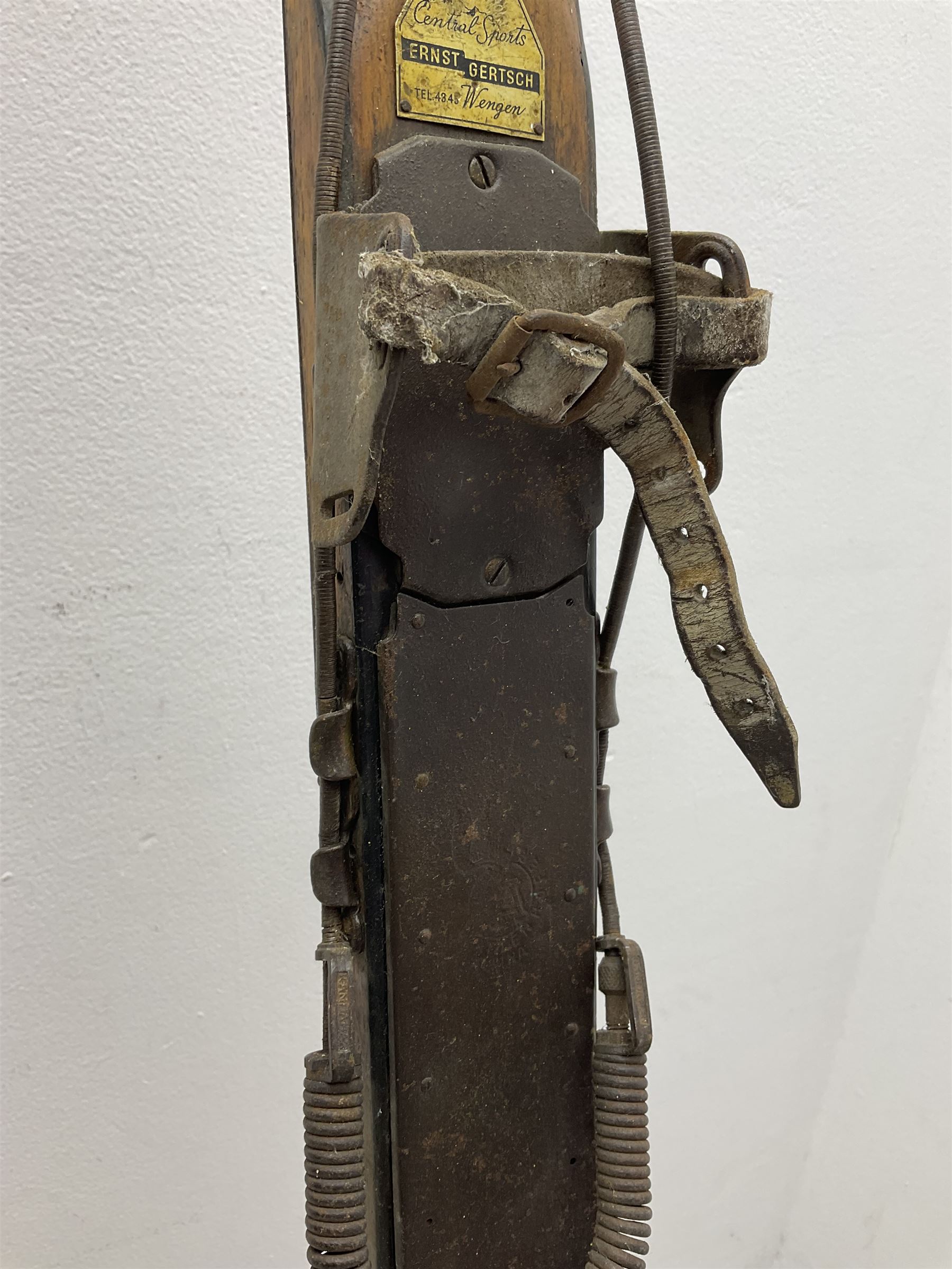 Pair of 1930s wooden skis, with painted metal runners beneath stamped Attenhofer, with retailers label for Ernst Gertsch Central Sports, L206cm