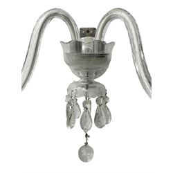 Pair of cut glass two branch wall sconce candelabras, each with S scroll extending branches with shaped and bevelled circular drip trays, hung with pendant drops