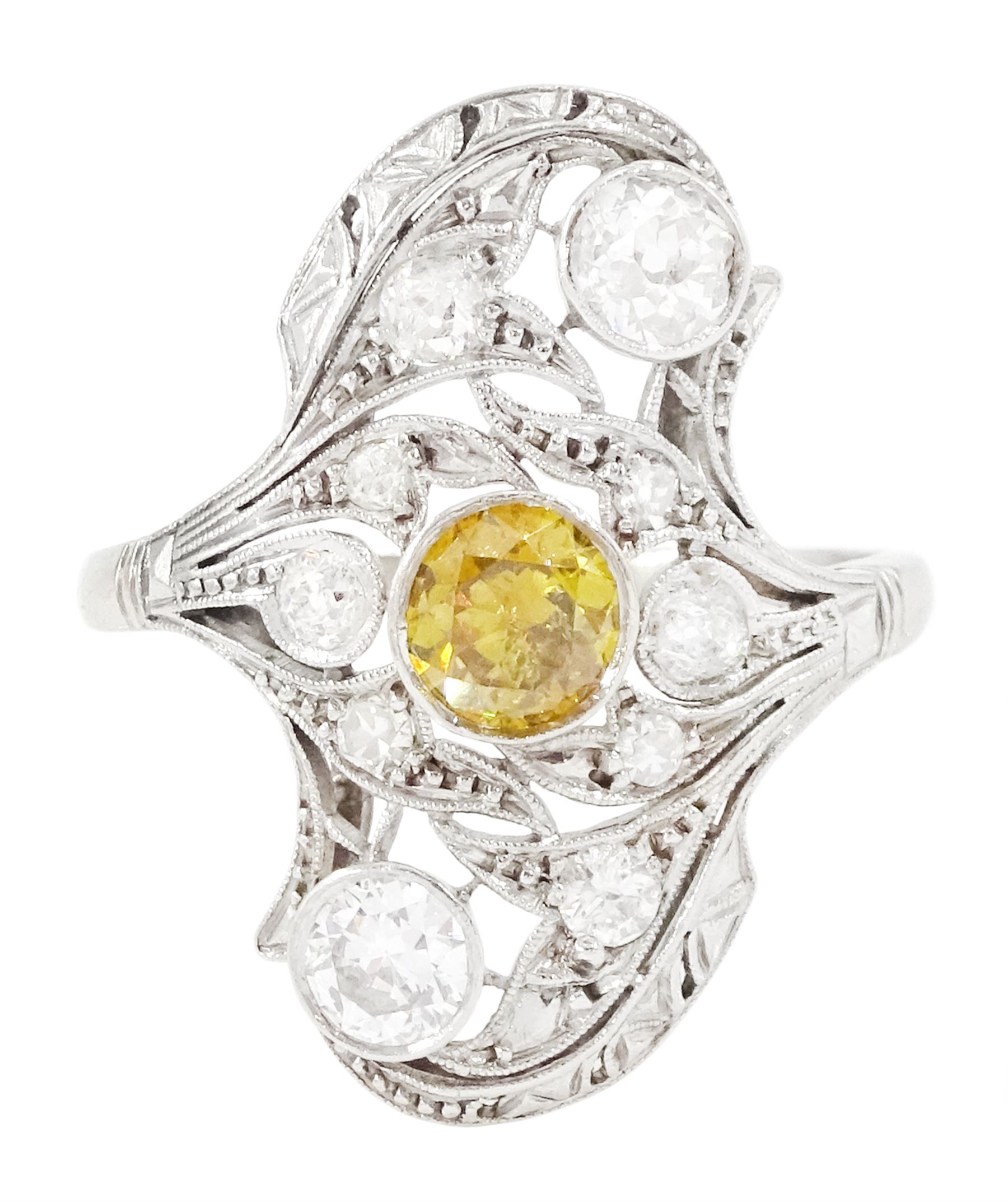 Early 20th century platinum diamond swirl ring, the principal old cut fancy yellow diamond of approx 0.50 carat, surrounded by old cut and single cut diamonds, in a milgrain pierced foliate design setting, total diamond weight approx 1.25 carat, with GCS certificate