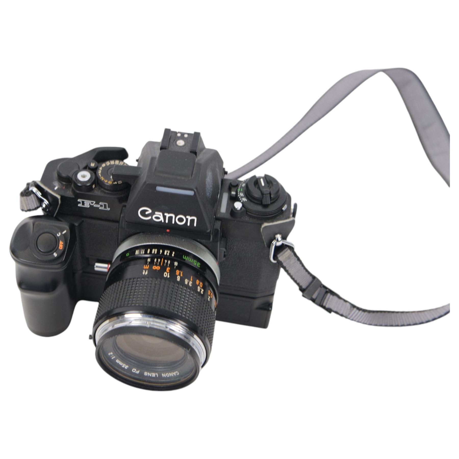 Canon F1 camera body, serial no. 223511, with 'Canon FD 35mm 1:2 FD' lens, serial no.23164, shoulder strap and Canon AE Power winder, serial no.174705