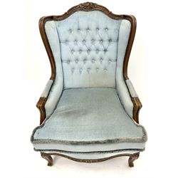 French style walnut framed wingback armchair, shaped and carved cresting rail, acanthus carved cabriole supports, upholstered in a buttoned light blue fabric