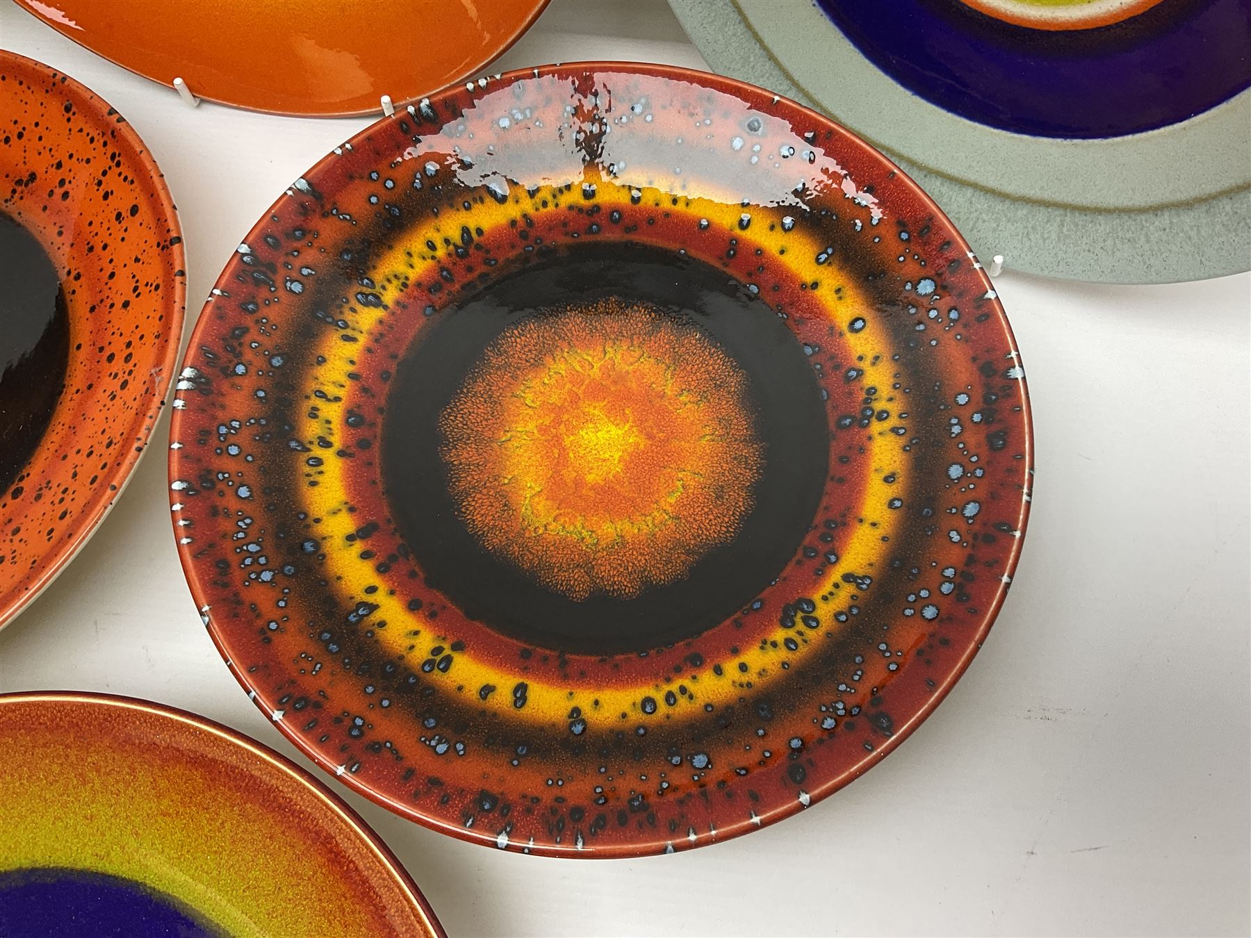 Poole Pottery The Planets, set of nine chargers 'The Planets, by Alan Clarke, comprising Mars, Mercury, Neptune, Venus, Uranus, Pluto, Jupiter, Saturn and Earth, all with original boxes and certificate, D27cm 