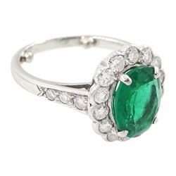 Platinum oval cut emerald and milgrain set, round brilliant cut diamond cluster ring, with diamond set shoulders, emerald approx 1.65 carat, total diamond weight approx 0.65 carat