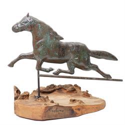 Copper weathervane formed as a leaping horse, mounted upon naturalistic base, W77cm