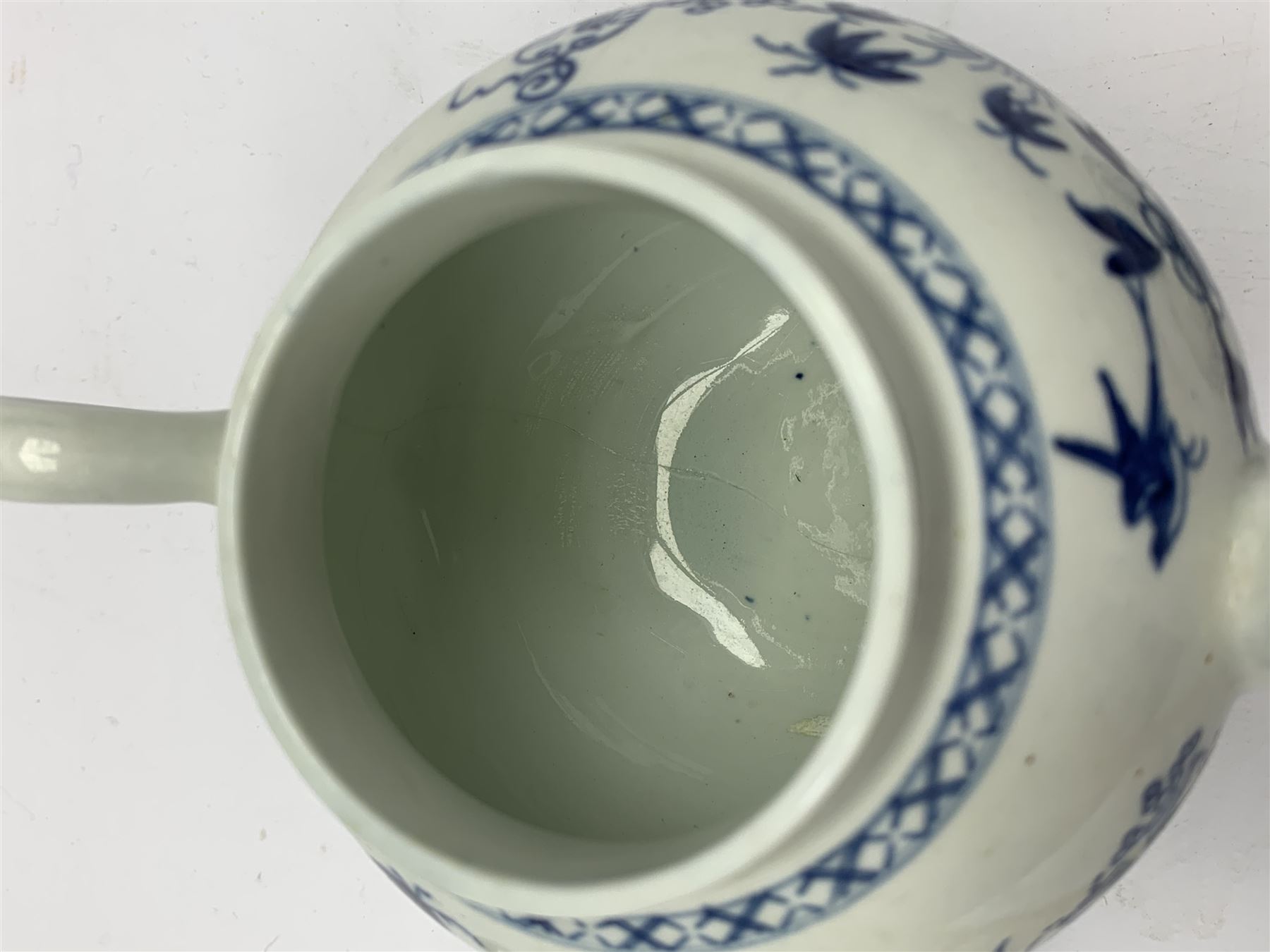 18th Century Worcester teapot, circa 1765-70, decorated in the Bird in the ring pattern, the cover with bud finial, with crescent mark beneath, H13cm, together with a Worcester coffee cup decorated in the same pattern, with crescent mark beneath, H6.5cm