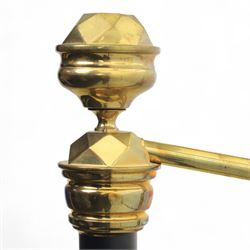 Victorian brass and iron 4' 6'' double bedstead, curved brass top rail with cast iron spindles and ornate floral rosettes flanked by urn shaped finials, foldable divan style base upholstered in a striped fabric, supported on turned posts and ceramic castors