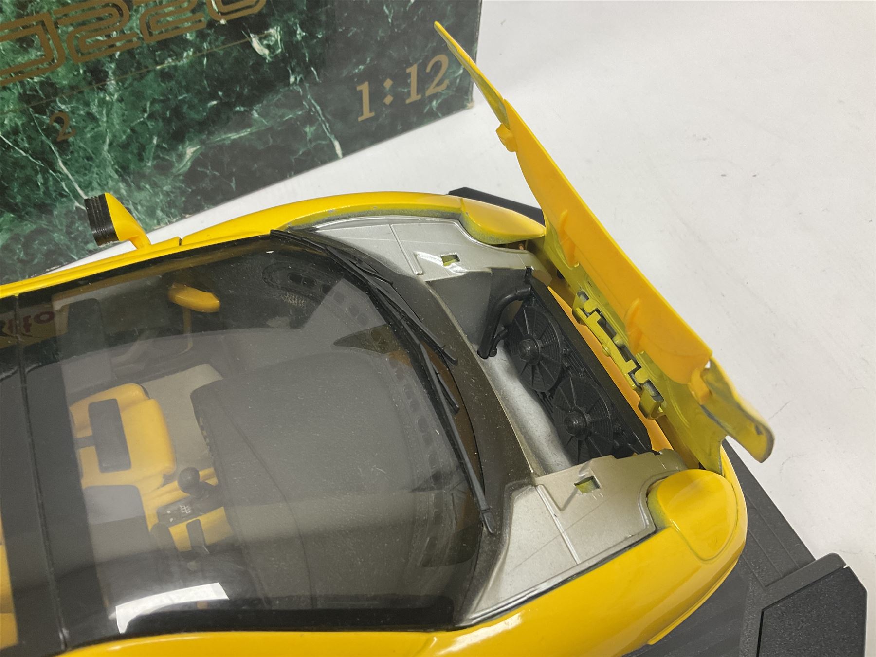 Two Maisto 1:12 scale Jaguar XJ220 ‘Racing’ cars in yellow, both on plinths in original boxes 