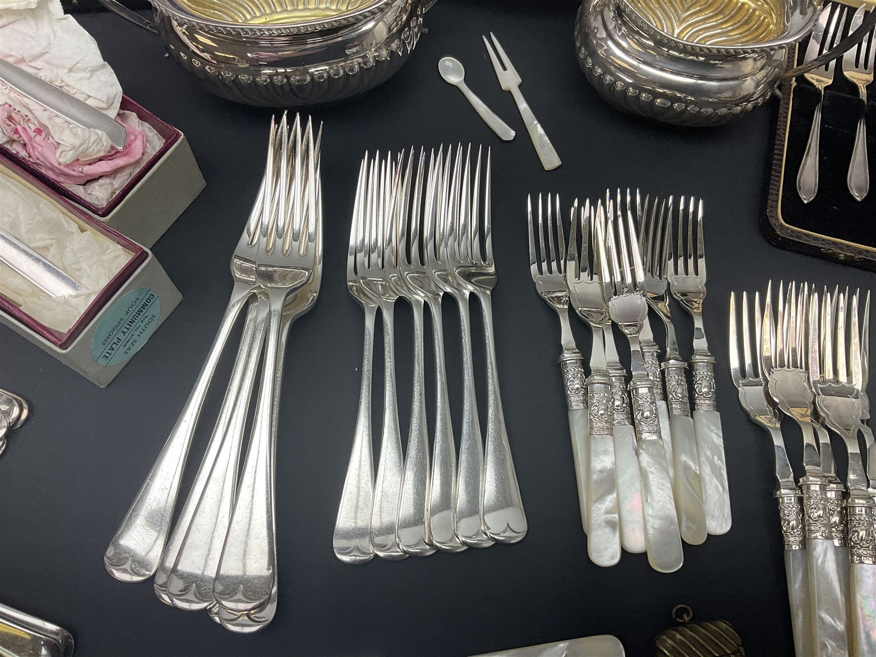 Mother of Pearl handled cutlery, with silver ferrules, comprising six fish knives and forks and six fruit knives and forks, the ferrules hallmarked Yates Brothers, Sheffield 1905, together with silver plated Edwardian three piece tea service and other flatware 