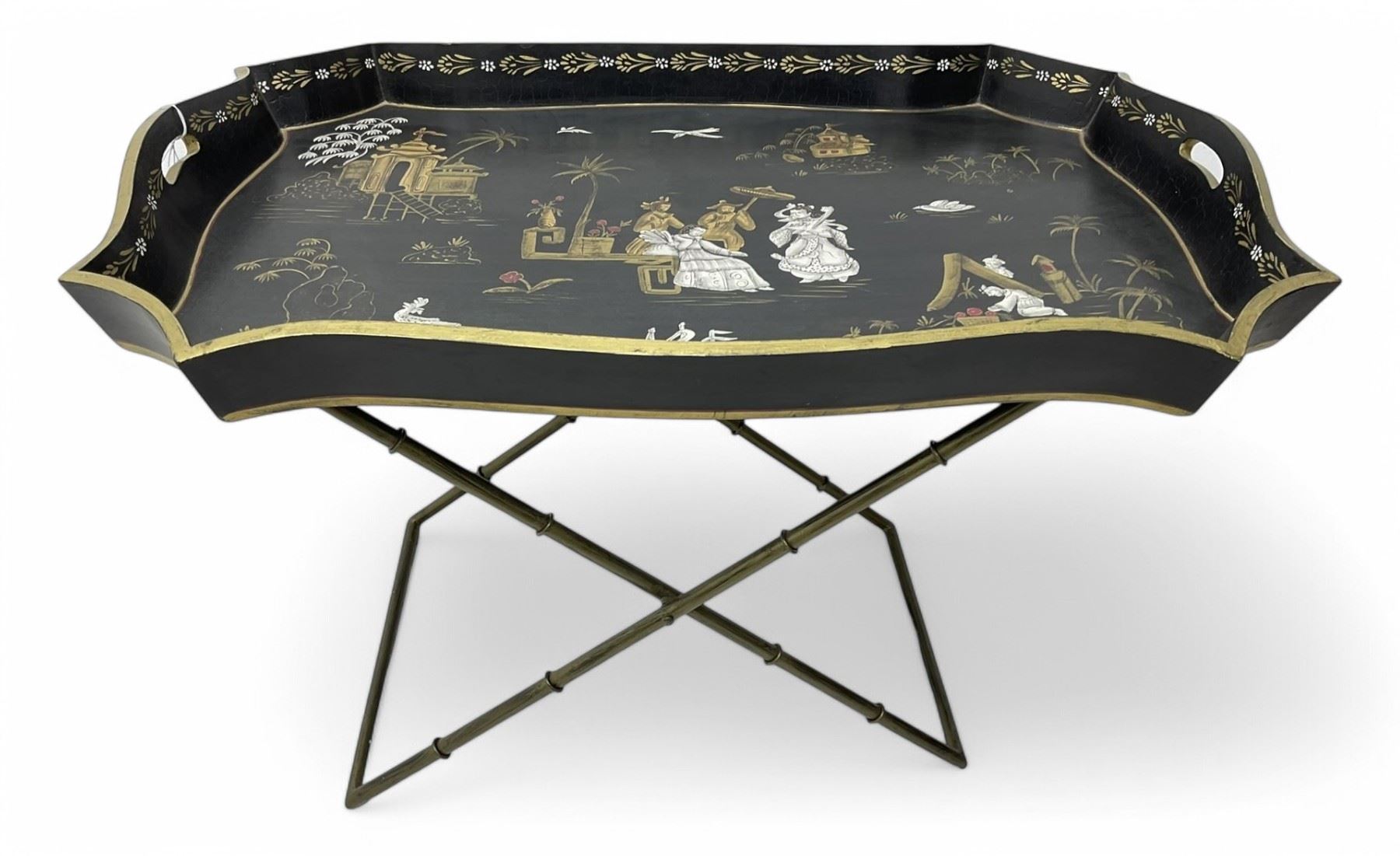 19th century design Chinoiserie style lacquered tray, painted with traditional scenes with figures and pagodas with gilt detail, on a folding simulated bamboo metal stand