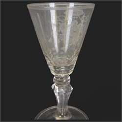 Two 18th century Continental facet cut drinking glasses, each with funnel bowl engraved with armorial type cartouche, upon a knopped and facet cut stem with internal elongated tear, and spreading folded foot, largest H15.5cm