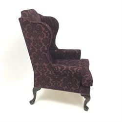 Traditional Queen Anne style high wingback armchair upholstered in purple fabric with raised scrolling pattern, on cabriole feet