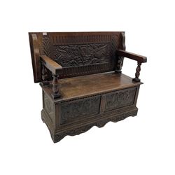 Late 19th century oak monk's bench, the hinged back or top carved with mythical winged dragons, central cartouche and scrolling acanthus leaves, on turned supports, hinged box seat revealing storage, the panelled front matching the back, shaped bracketed skirt carved with shell and scrolled leafage