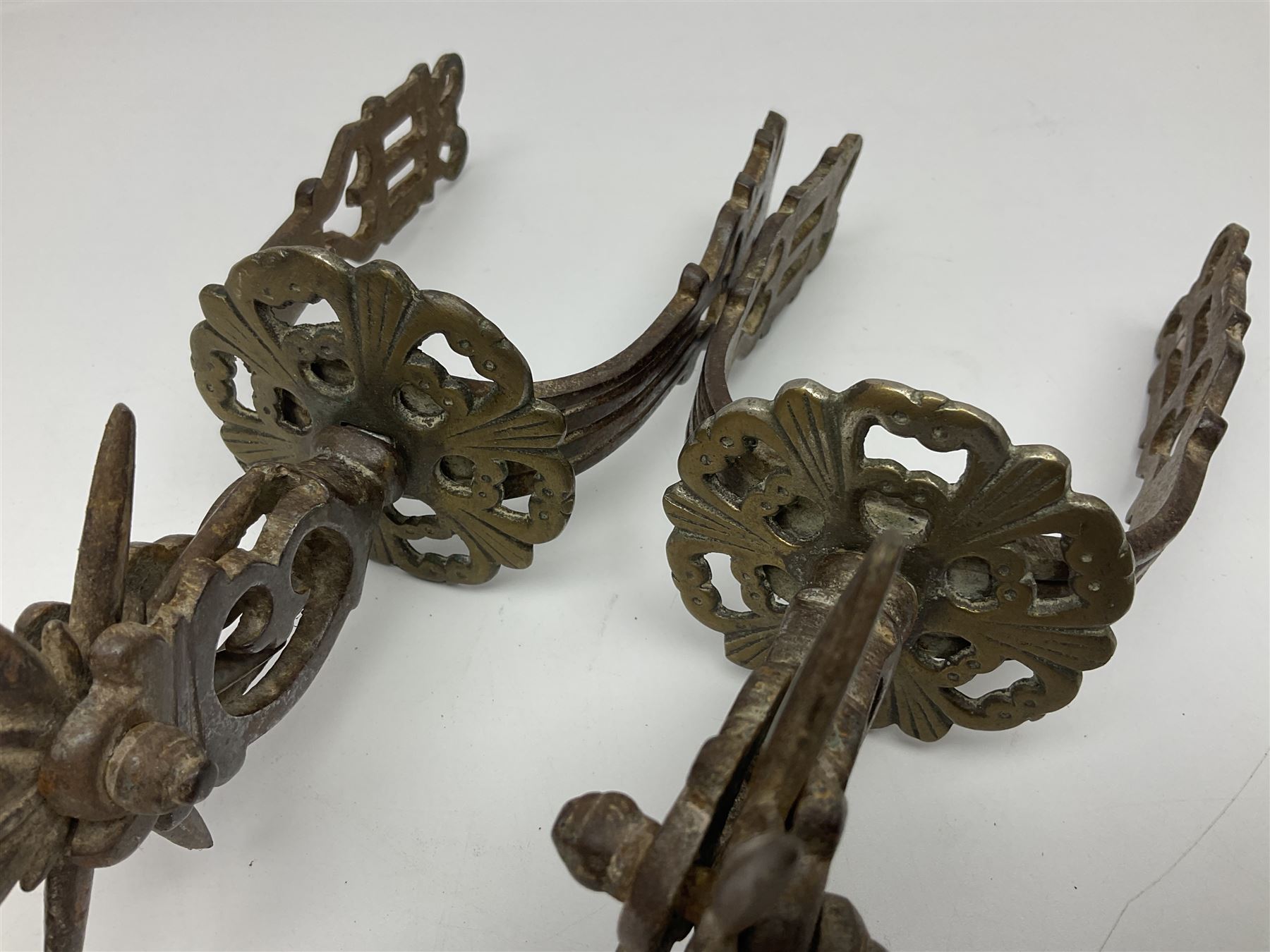 Pair of South American gaucho steel and brass spurs with eight-spike heel rowels, possibly Chilean L25cm