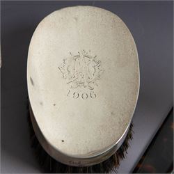 Edwardian tortoiseshell page turner with silver handle, hallmarked Birmingham 1906, maker's mark worn and indistinct, together with a pair of Edwardian silver mounted horsehair brushes engraved with monogram, and two faceted glass jars with silver lids and applied initial N to covers, all hallmarked 