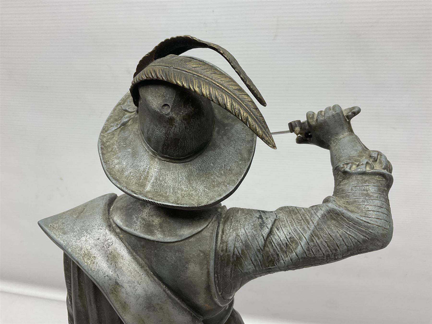 Spelter figure modeled as Cavalier with a raised sword, upon a circular base, H52cm