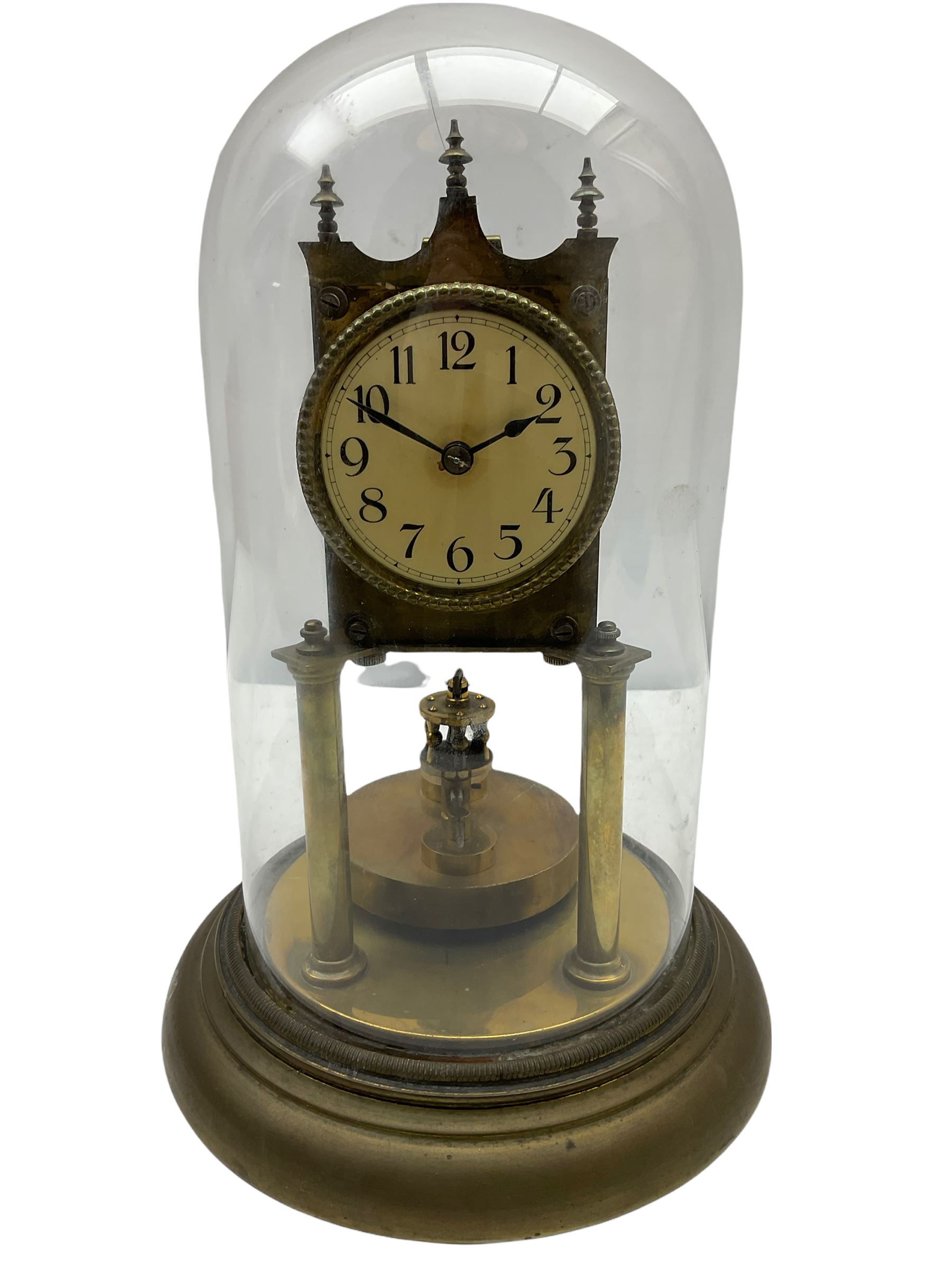 An anonymous early 20th century German 400-day torsion clock, with a circular enamel dial, upright Arabic numerals and minute track, spade hands under a glass shade, circular rotating pendulum with regulation, on a circular brass base with adjustable feet. 
H33cm

