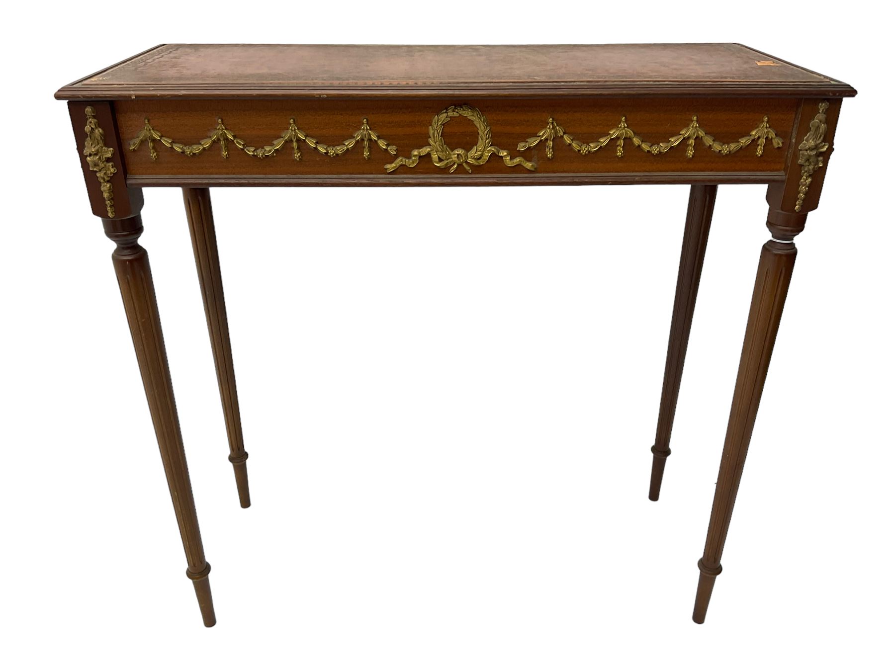 Early 20th century mahogany side table, inset amber leather surface, frieze decorated with applied gilt festoons and central wreath, on tapering fluted supports