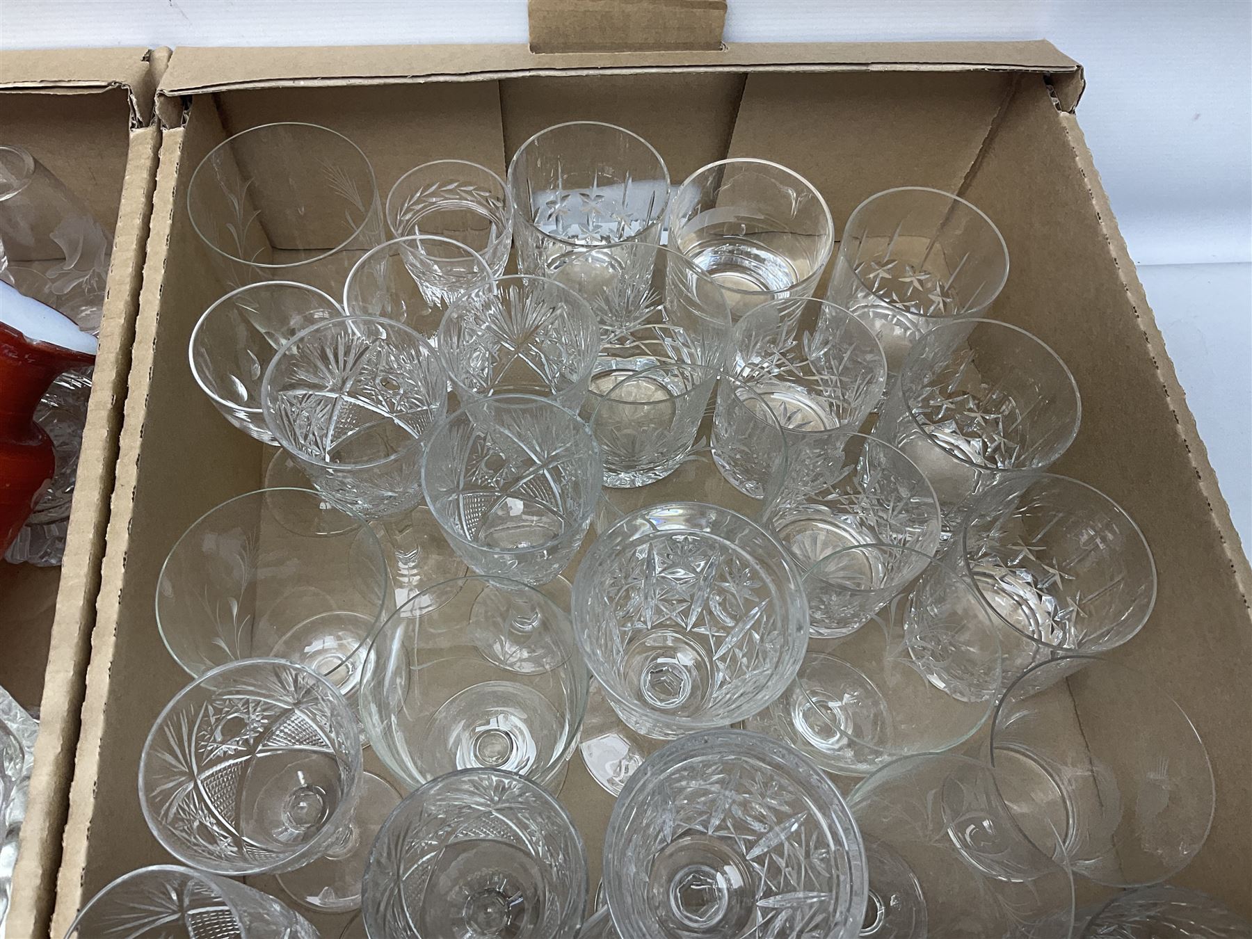 Four boxes of glassware to include painted vases, jugs, drinking glasses, art glass vase etc