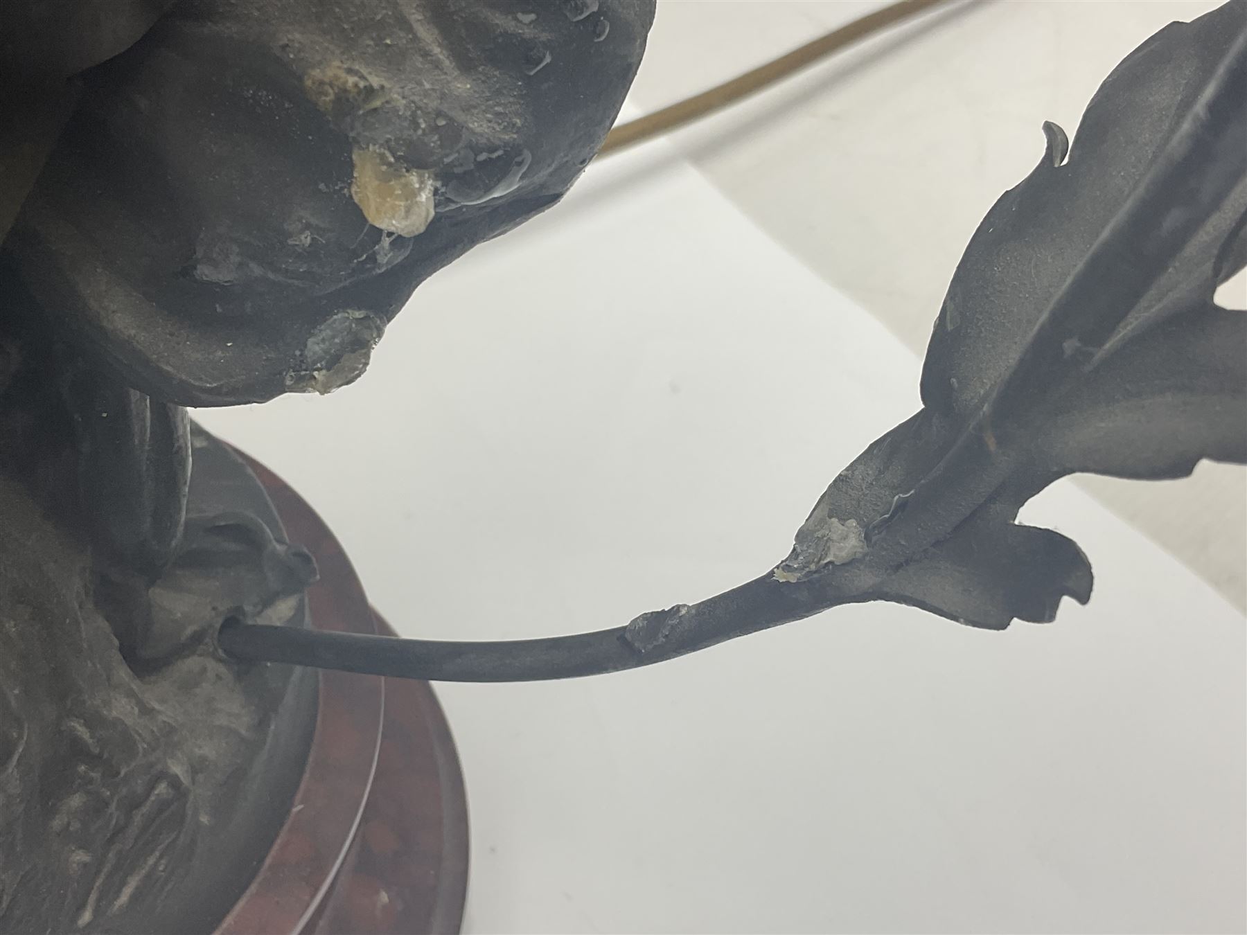 Pair of Art Nouveau style spelter figural table lamps, each mounted on rouge marble effect circular bases, with toleware flower heads and leafy decoration surrounding a female figure, H90cm